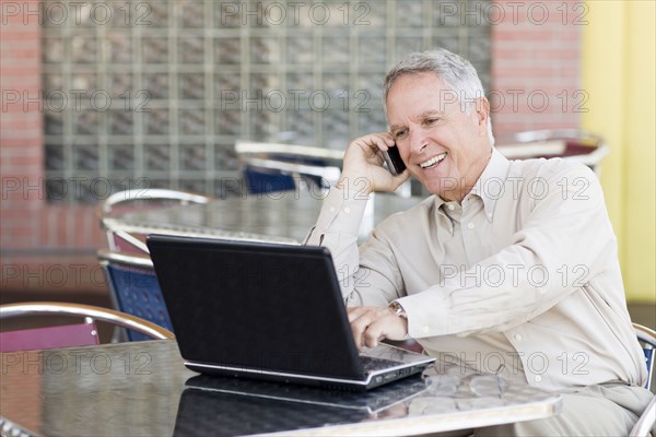 Caucasian businessman working at cafe