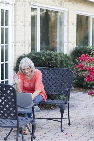 Caucasian woman using laptop outdoors