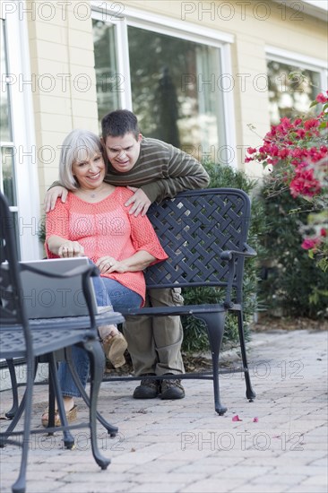 Caucasian mother and son using laptop outdoors