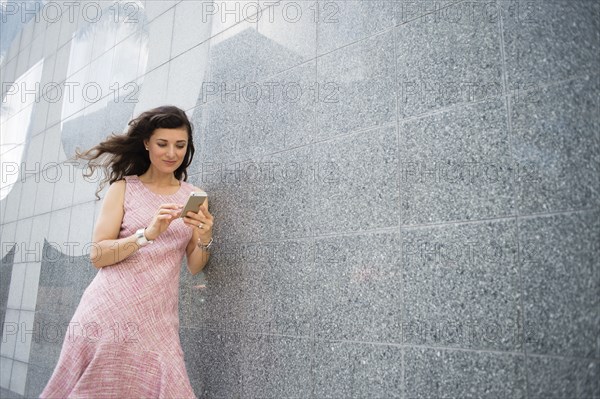 Caucasian woman using cell phone outdoors