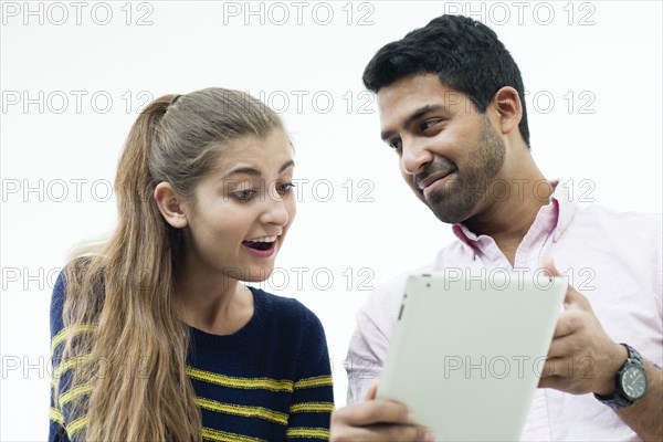 Low angle view of couple using digital tablet