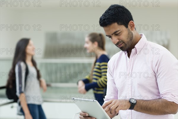 Student using digital tablet on campus