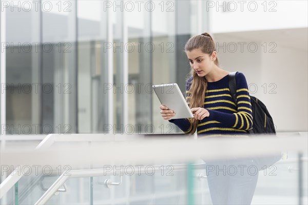 Caucasian student using digital tablet on campus