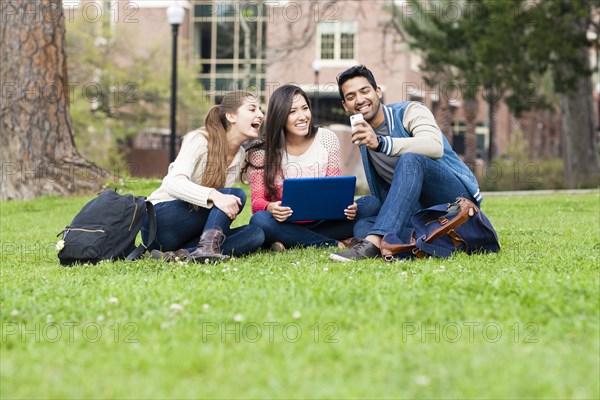 Students taking cell phone photograph on campus