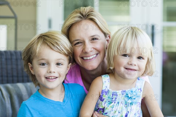 Caucasian mother and children smiling outdoors