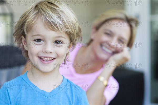 Caucasian boy smiling with mother