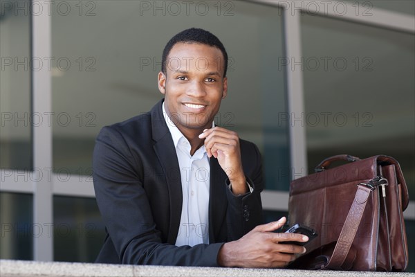 Black businessman using cell phone