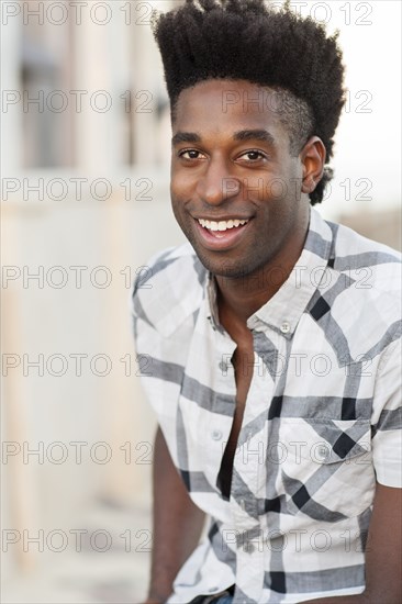 Black man smiling outdoors