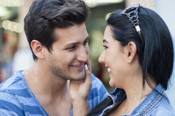 Close up of Hispanic couple hugging