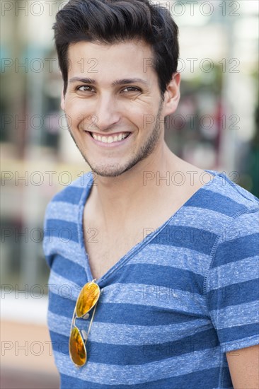 Hispanic man wearing sunglasses on shirt