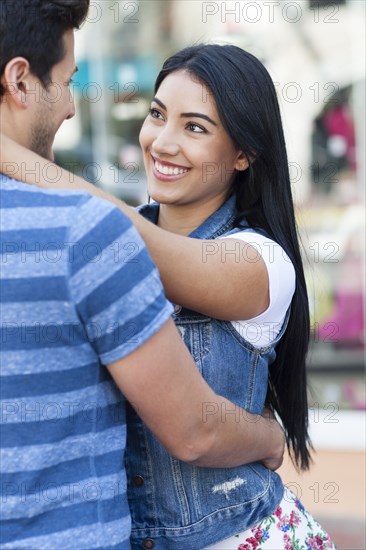 Close up of Hispanic couple hugging