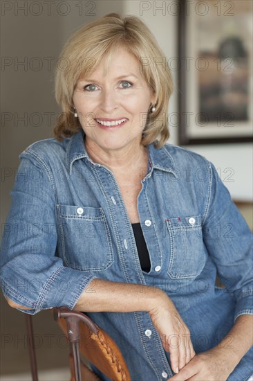 Smiling Caucasian woman sitting in chair