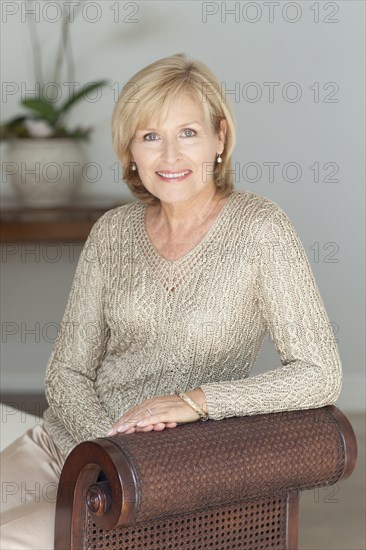 Smiling Caucasian woman sitting on bench