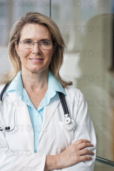 Caucasian doctor smiling with arms crossed