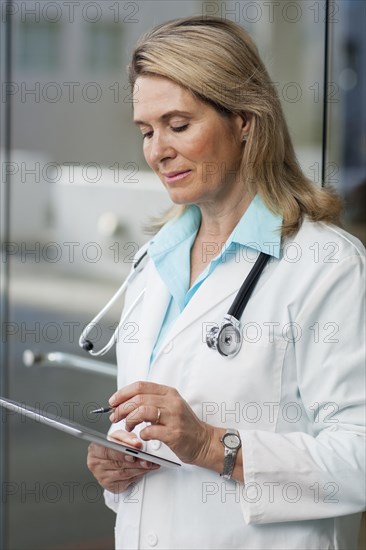 Caucasian doctor using digital tablet in hospital