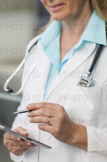 Close up of Caucasian doctor using digital tablet