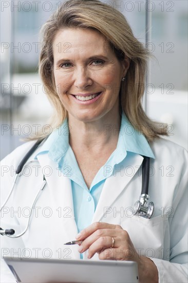 Close up of Caucasian doctor using digital tablet