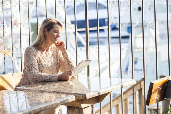 Caucasian woman using digital tablet in cafe