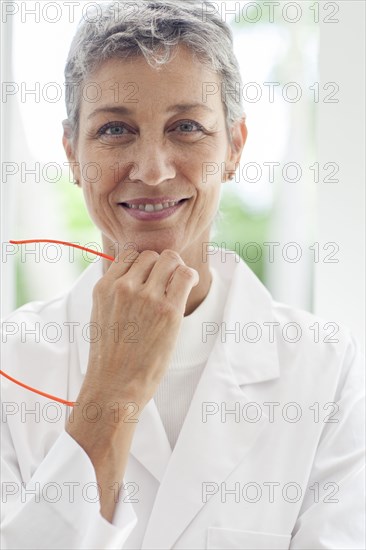 Close up of smiling doctor resting chin in hand