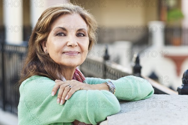 Middle Eastern woman leaning on gate