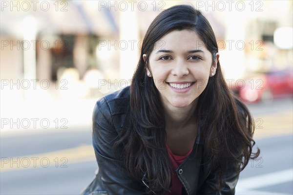 Hispanic woman smiling outdoors