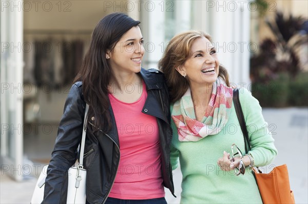 Mother and daughter walking outdoors