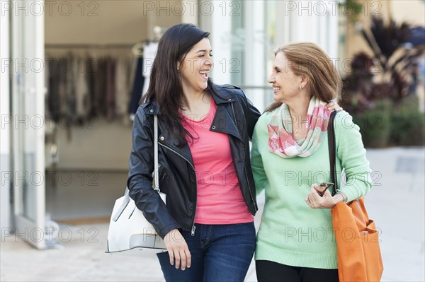 Mother and daughter walking outdoors