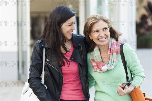 Mother and daughter walking outdoors