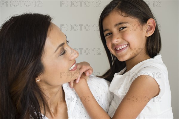 Close up of mother and daughter hugging