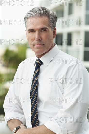 Close up of serious Caucasian businessman outdoors