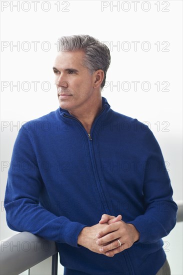 Caucasian businessman overlooking view from balcony