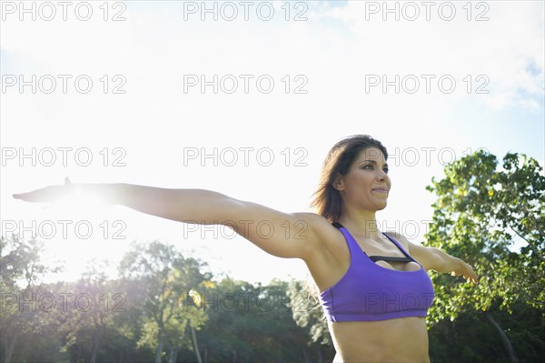 Caucasian athlete practicing yoga in park