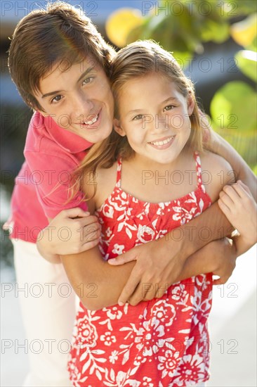 Close up of Caucasian brother and children hugging