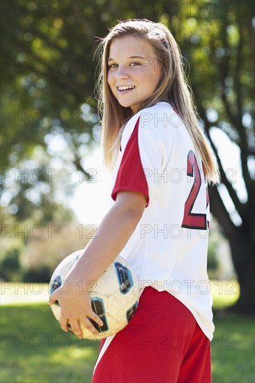 Caucasian soccer player holding ball