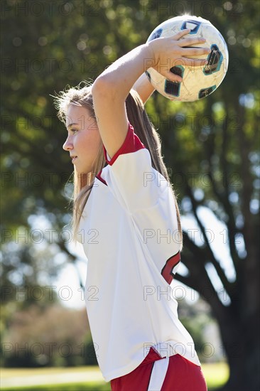 Caucasian soccer player throwing ball