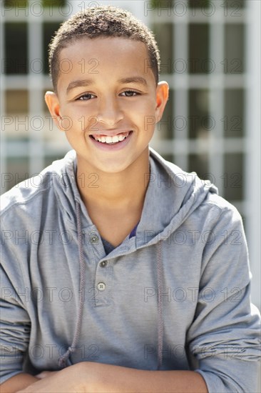 Close up of mixed race boy smiling outdoors