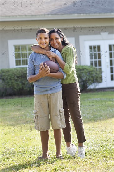 Mother and son hugging in backyard