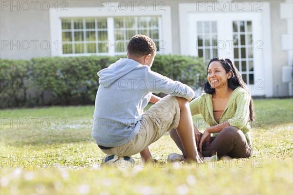 Mother and son talking in backyard