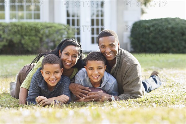 Smiling family playing in backyard