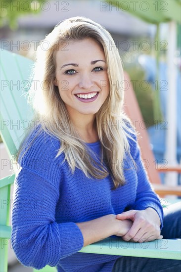 Caucasian woman sitting in deck chair outdoors