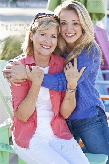 Caucasian mother and daughter hugging outdoors