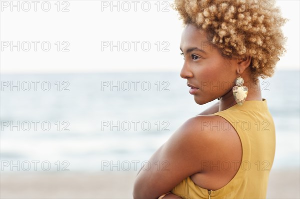 Profile of pensive Black woman at beach