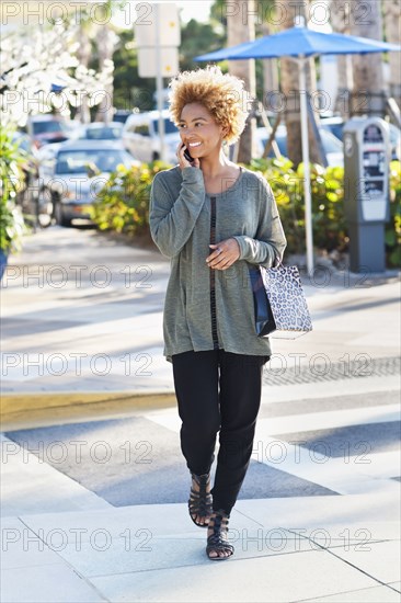 Black woman crossing city street