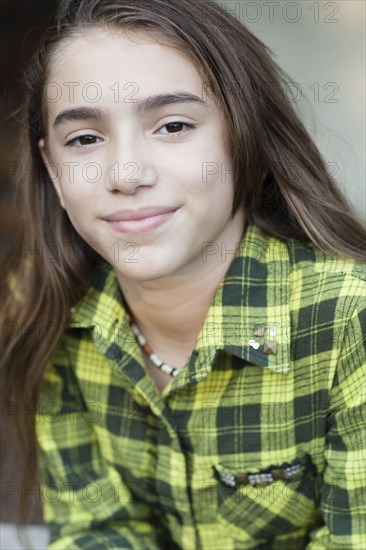 Close up of Hispanic girl wearing plaid shirt