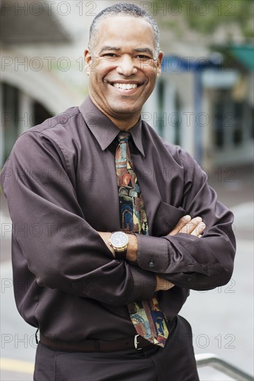 African American businessman standing with arms crossed