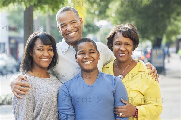 African American family smiling in city