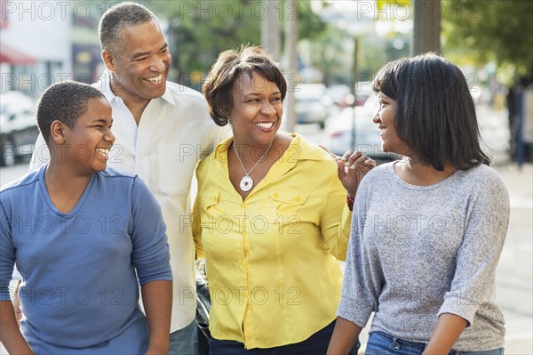 African American family walking in city