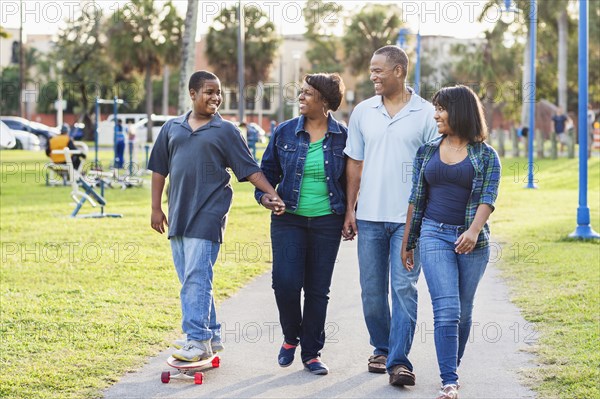 African American family relaxing in park