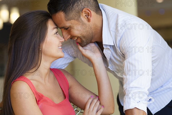 Smiling Hispanic couple rubbing noses