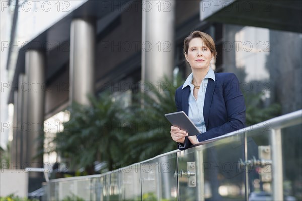 Caucasian businesswoman using digital tablet outdoors